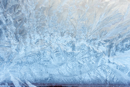 Beautiful natural background or texture of frozen transparent glass on the window in winter, strong cold concept, horizontal image, copy space for your design or textの写真素材