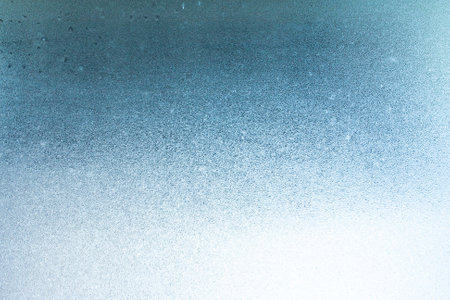 Winter background on a transparent glass of a window with a frozen texture. Abstract texture background, horizontal image, copy space for your design or textの写真素材