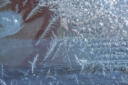 Beautiful natural background or texture of frozen transparent glass on the window in winter, strong cold concept, horizontal image, copy space for your design or textの写真素材