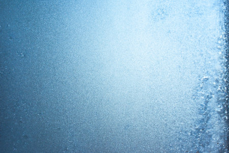 Beautiful natural background or texture of frozen transparent glass on the window in winter, strong cold concept, horizontal image, copy space for your design or textの写真素材