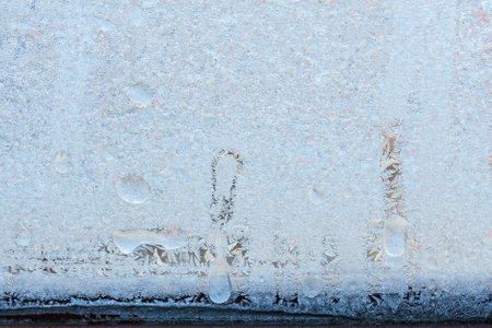 Beautiful natural background or texture of frozen transparent glass on the window in winter, strong cold concept, horizontal image, copy space for your design or textの写真素材