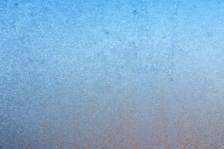 Beautiful natural background or texture of frozen transparent glass on the window in winter, strong cold concept, horizontal image, copy space for your design or textの写真素材