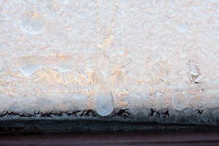 Beautiful natural background or texture of frozen transparent glass on the window in winter, strong cold concept, horizontal image, copy space for your design or textの写真素材