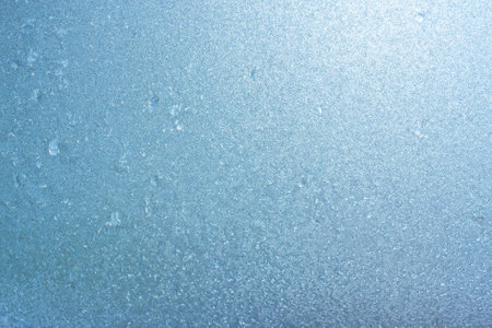 Winter background on a transparent glass of a window with a frozen texture. Abstract texture background, horizontal image, copy space for your design or textの写真素材