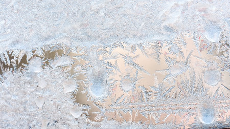 Frost patterns on the window, hoarfrost background. Frosty Christmas pattern on the winter window glass. Copy space, natural texture, macroの写真素材