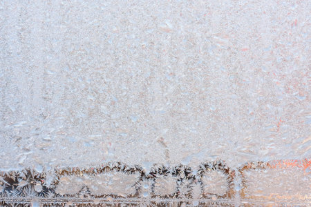 Graceful expressive winter natural background, macro texture. Copy space. Frosty pattern on winter window glassの写真素材