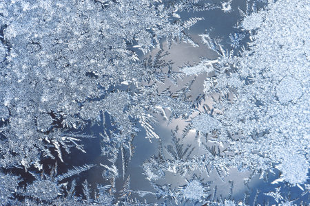 Graceful expressive winter natural background, macro texture. Copy space. Frosty pattern on winter window glassの写真素材