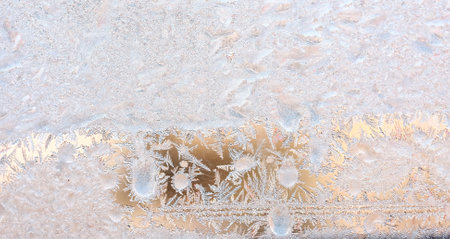 Graceful expressive winter natural background, macro texture. Copy space. Frosty pattern on winter window glassの写真素材