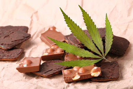 Hemp Chocolate Chip Cookies with THC and CBD. Organic Marijuana Chocolate Chunks with Nuts and CBD Cannabis Supplement and Green Hemp Leavesの写真素材