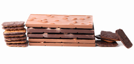 Chocolate bars with nuts and chocolate chip cookies closeup on white isolated background with cutoutの写真素材