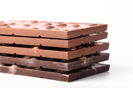 Chocolate bars with nuts close up on white isolated backgroundの写真素材