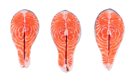Three salmon steaks, fresh fish slice, trout on white isolated backgroundの写真素材