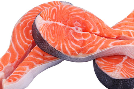 Raw fish salmon steak prepared for cooking on white isolated backgroundの写真素材