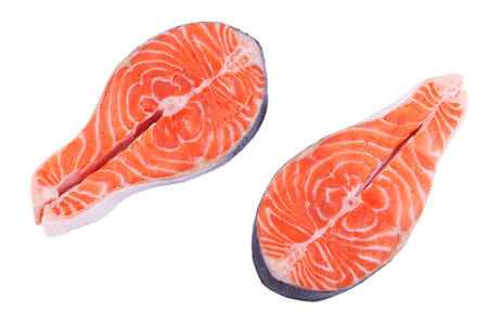 Raw fish salmon steak prepared for cooking, top view on white isolated backgroundの写真素材