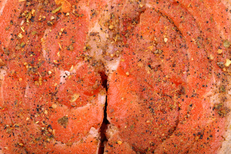 Red raw fresh fish steaks with spices close-up prepared for cookingの写真素材