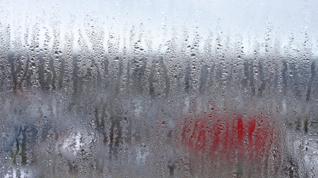 Background of natural condensation of water on transparent glass with high air humidity, large drops drippingの写真素材