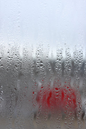Vertical background of condensation on transparent glass with high humidityの写真素材