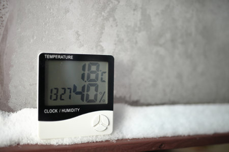 The humidity indicator is indicated on a hygrometer installed on the snow. Picture of an electronic device for testing air temperature and humidityの写真素材