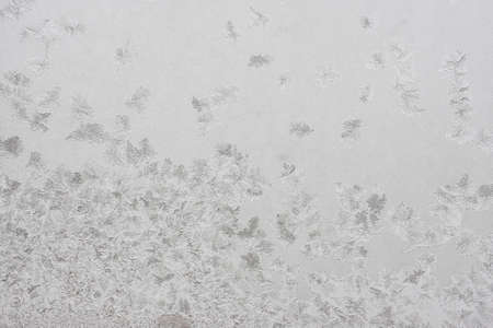 Beautiful winter background, frost on the window, natural texture on glass with a frozen pattern. Copy space, natural background, macroの写真素材