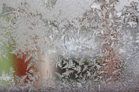 Beautiful winter background, frost on the window, natural texture on glass with a frozen pattern. Copy space, natural background, macroの写真素材