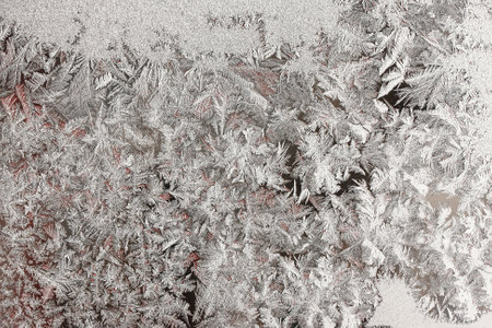 Frozen winter abstract background with a pattern on the window glassの写真素材