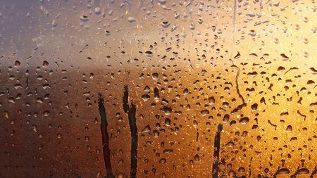 Drops condensation on the clear glass window. Water drops. Abstract background texture, condensation on the glass with dripping dropsの写真素材