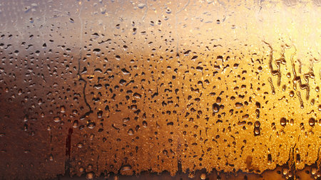 Drops condensation on the clear glass window. Water drops. Abstract background texture, condensation on the glass with dripping dropsの写真素材