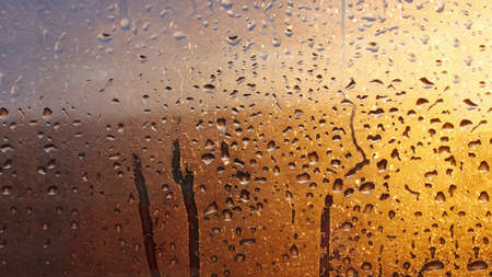 Drops condensation on the clear glass window. Water drops. Abstract background texture, condensation on the glass with dripping dropsの写真素材
