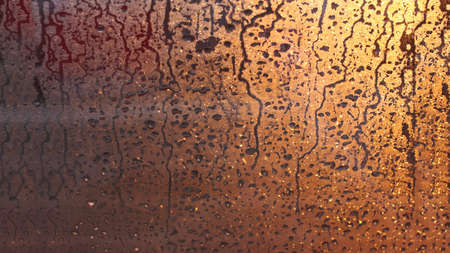Natural background of condensation, drops of flowing water on the window paneの写真素材