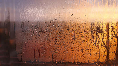Drops condensation on the clear glass window. Water drops. Abstract background texture, condensation on the glass with dripping dropsの写真素材