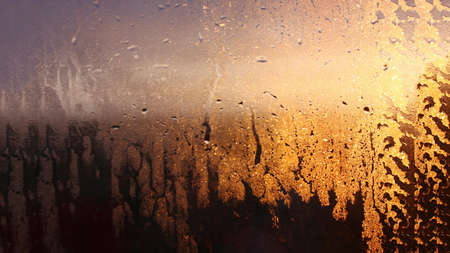 Natural background of condensation, drops of flowing water on the window paneの写真素材