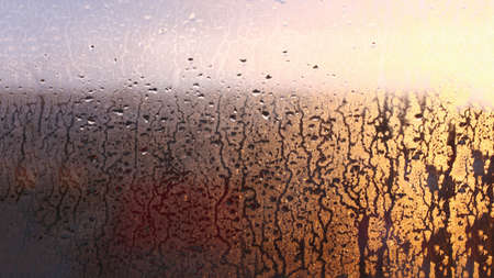 Drops condensation on the clear glass window. Water drops. Abstract background texture, condensation on the glass with dripping dropsの写真素材