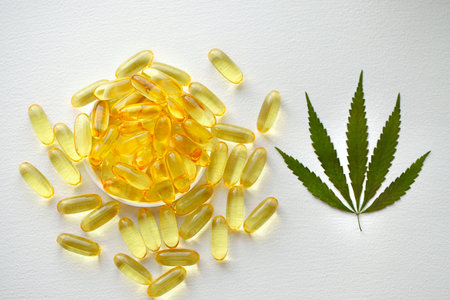 Medical cannabis products, leaf, capsules and CBD oil on white background. Pharmaceutical gelatin softgels with biological plant herbal. Organic dietary supplements conceptの写真素材