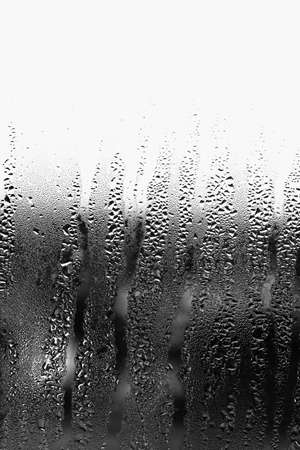 Vertical background of condensation on transparent glass with high humidityの写真素材