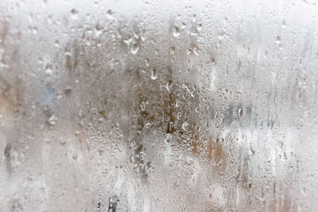 Background of natural water condensation, window glass with high air humidity, large drops drip. Collecting and streaming downの写真素材