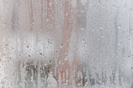 Condensation on the clear glass window, Water drops, Rain. Window glass with high air humidity. Background of natural water condensationの写真素材