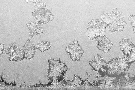 Frost on the window, Natural texture on glass with frozen pattern. Copy space, natural background, macro. Beautiful winter backgroundの写真素材