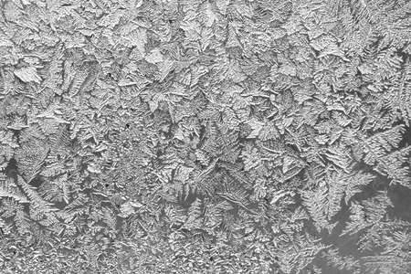 Frost on the window, Natural texture on glass with frozen pattern. Copy space, natural background, macro. Beautiful winter backgroundの写真素材