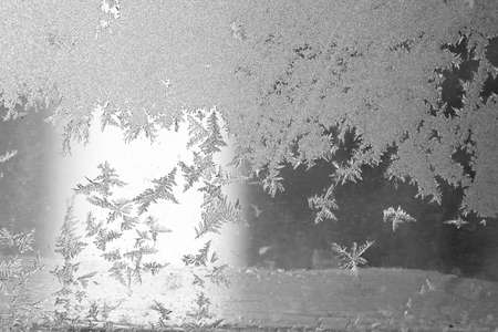 Frost on the window, Natural texture on glass with frozen pattern. Copy space, natural background, macro. Beautiful winter backgroundの写真素材