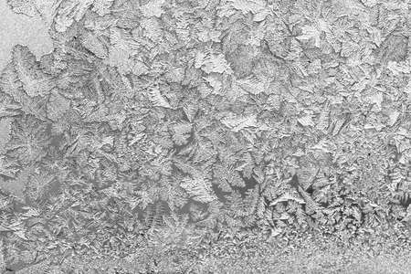 Frost on the window, Natural texture on glass with frozen pattern. Copy space, natural background, macro. Beautiful winter backgroundの写真素材
