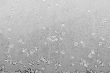 Frost on the window, Natural texture on glass with frozen pattern. Copy space, natural background, macro. Beautiful winter backgroundの写真素材