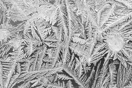 Frost on the window, Natural texture on glass with frozen pattern. Copy space, natural background, macro. Beautiful winter backgroundの写真素材