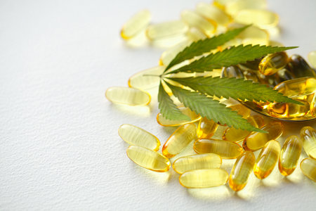 Biological and ecological CBD vegetable oil capsules on white background, Group of transparent CBD cannabidiol capsules. Medical cannabis productsの写真素材
