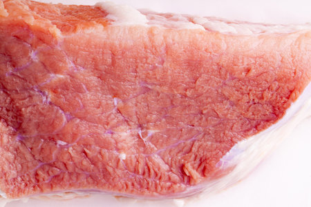 Piece of fresh red meat close up isolated on white background. Suitable for use as backgroundの写真素材