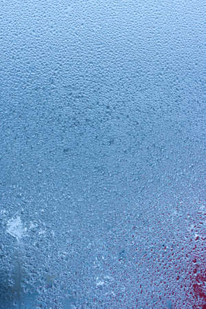Condensation on the clear glass window. water drops. Rain. abstract background texture. Outside the window, bad weather, rainの写真素材