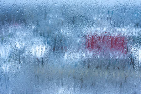 Condensation on the glass of a metal-plastic window in a room, high humidity in the roomの写真素材