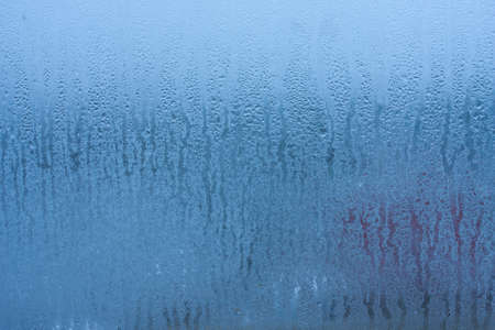 Condensation on the glass of a metal-plastic window in a room, high humidity in the roomの写真素材