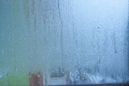Background water drops on the glass, wet window glass with splashes and drops of water and lime,...