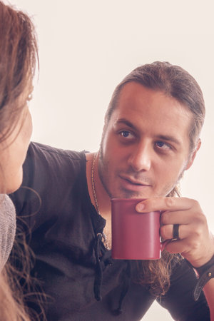 man with a cup of coffee looking at girl
