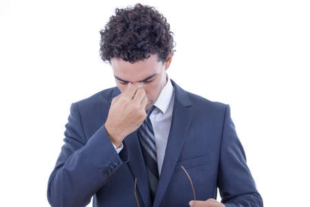 young businessman in suit having hard headacheの写真素材